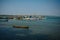 Colorful fishing boats with blue and white hulls and Indian flags on the masts, on the fishing pier in Goa. Wooden boats