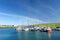 Colorful fishing boats and yachts at the harbor of Dingle town on the West Atlantic coast of Ireland. Towns and villages on famous