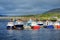 Colorful fishing boats and yachts at the harbor of Portmagee town on the West Atlantic coast of Ireland.