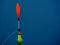 colorful fishing bobber on blue water background