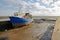 A colorful fishing trawler moored at the quay with the muddy beach at low tide, Leigh on Sea