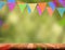 Colorful flag banner and confetti on wood table with blur green