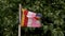 A colorful flag tied to a pole swaying in the wind