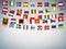 Colorful flags of different countries of the europe with confetti on grey background. Festive garlands of the international