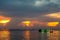 colorful flame cloud sunset fisging boat on sea and sky