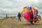 A colorful floater salesman walking on a beach