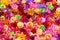 Colorful floral background, vibrant colors of artificial flowers
