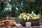 Colorful flower arrangements are set up on a wooden table