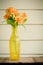 Colorful flower in transparent yellow vase