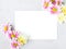 Colorful flowers on white background. Flat lay, top view. Space for text.