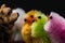 Colorful fluffy chickens for Easter decoration and a puppy figure on a black background