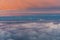 Colorful fluffy clouds outside an airplane at sunset