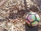 Colorful football or soccer ball on ground