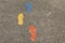 Colorful footsteps painted on cement, leading people in a positive direction