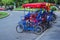 Colorful four wheeled bicycles â€“ promenade vehicle in city park of Budapest