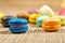 Colorful france macarons on wooden background - selective focus