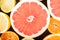 Colorful fresh citrus fruit on wooden background. Orange, tangerine, lime, blood orange, grapefruit. Fruit background. Summer foo