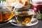 Colorful fresh herbal brewed teas in glass teapots