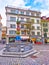 Colorful Fritschi Fountain with carnival masks on Kapellplatz in Lucerne, Switzerland