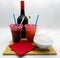 Colorful frozen drinks, bottle, ice cubes, red paper towels, white background