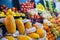 Colorful fruit stand with papayas, red and yellow apples, and more