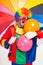 Colorful funny clown holding balls