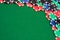 Colorful gambling chips on green felt background