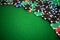 Colorful gambling chips on green felt background