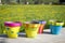 Colorful garden pots next to flowering field