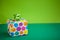 Colorful gift box on lime color background. Holiday greeting card