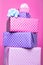 Colorful gift boxes with ribbon over pink background. Pink, purple, pastel, bright