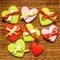 Colorful gingerbread cookies tied with ribbons with pieces of pa