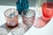 Colorful glass candlesticks on a white windowsill with bright highlights and long shadows from the sunlight