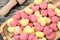 Colorful gnocchi hearts on a old table with rolling pin