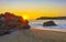 Colorful golden sunset big wave rocks beach Puerto Escondido Mexico