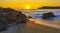 Colorful golden sunset big wave rocks beach Puerto Escondido Mexico