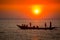 Colorful golden Sunset on Sea. Fishermans are returning home with fish, manually at sunset on Char Samarj beach at Chandpur,