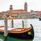 Colorful gondola boat at the water, venetian houses and canal view