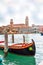 Colorful gondola boat at the water, venetian houses and canal view