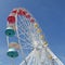Colorful gondolas of an amusement park Ferris wheel