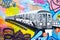 Colorful graffiti in New York City with an image of a subway tra