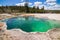 Colorful green Abyss Pool hot spring in West Thumb Geyser Basin in Yellowstone National Park