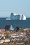 Colorful green blue wooden houses with icebergs in the background. Rodebay, also known as Oqaatsut is a fishing