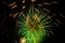 Colorful green fireworks on the black sky