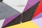 Colorful grey, purple, yellow, red and black painted wall with cracks