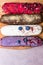 colorful group of delicious eclairs on wooden board