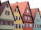 Colorful half-timbered townhouses with exterior shutters at windows