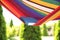 Colorful hammock with book outdoors