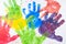 Colorful hand paint from kids hands on white paper