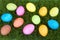 Colorful hand painted decorated easter eggs in grass